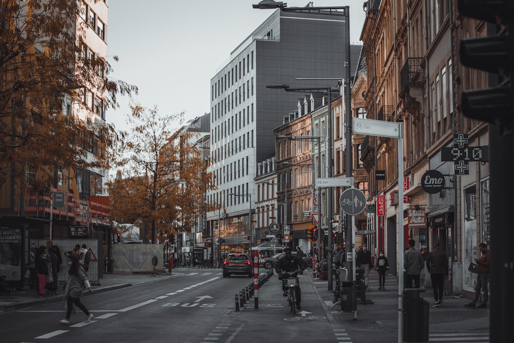 A bustling street in Luxembourg City, capturing urban life amid modern and classic architecture.