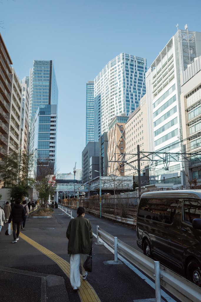A vibrant street scene in Shibuya, Tokyo featuring modern skyscrapers and pedestrians.