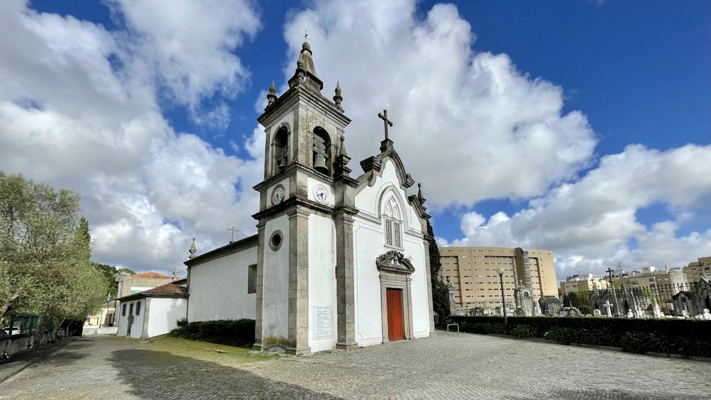 Beautiful view of Ramalde Church in Porto under a blue sky with clouds.