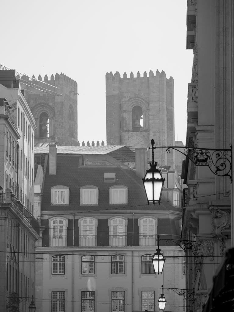 Black and white view of Porto's iconic towers with antique lamps highlighting urban architecture.