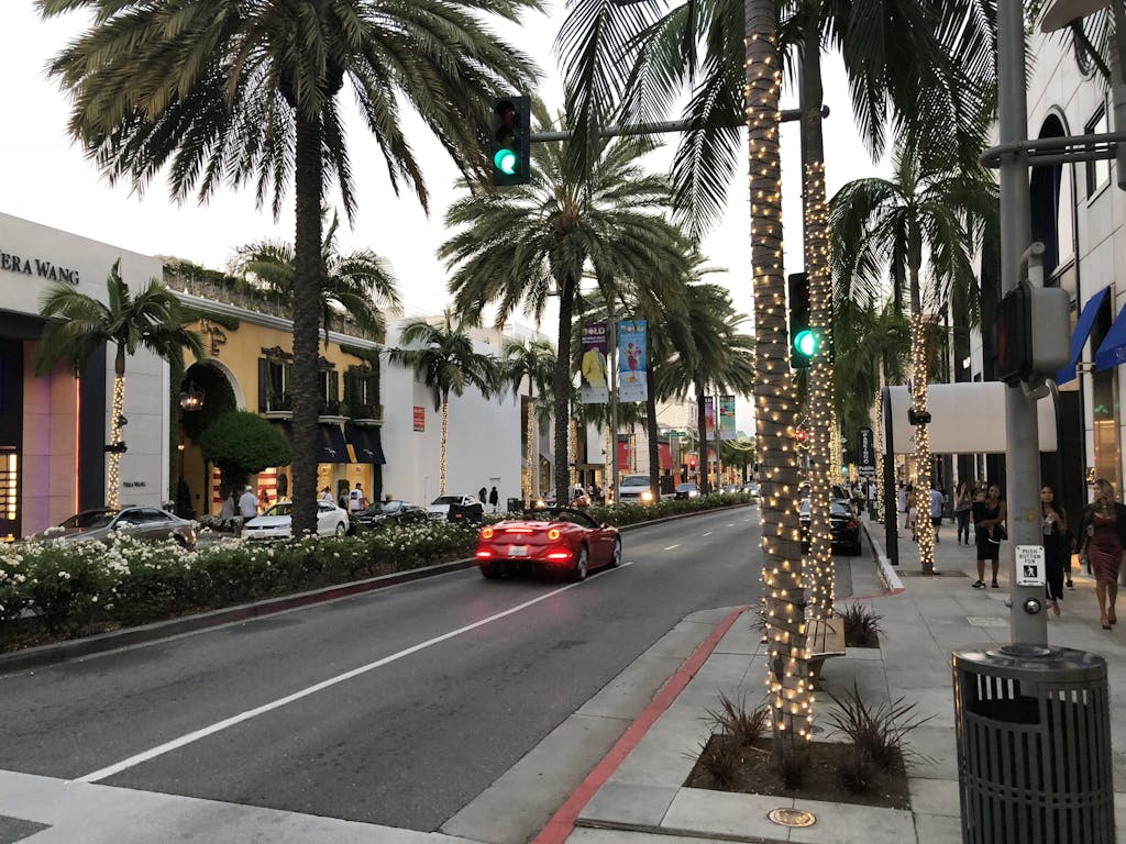 Captivating view of Rodeo Drive with palm trees and luxury shops at dusk in Beverly Hills.