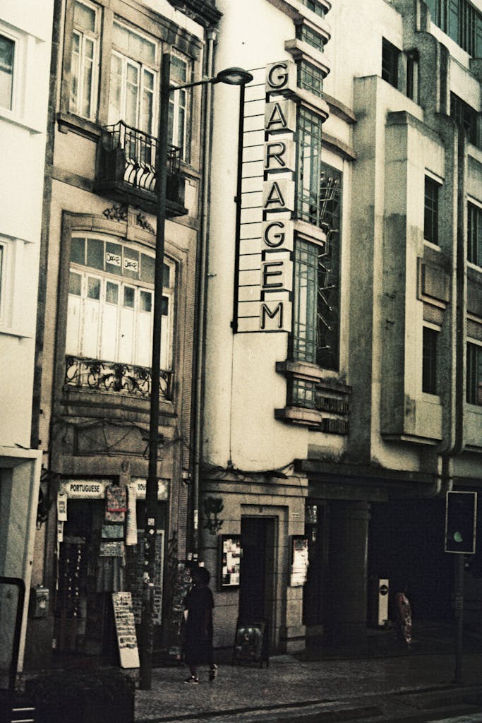 Classic facade of garage building in Porto, Portugal with vintage sepia tone.