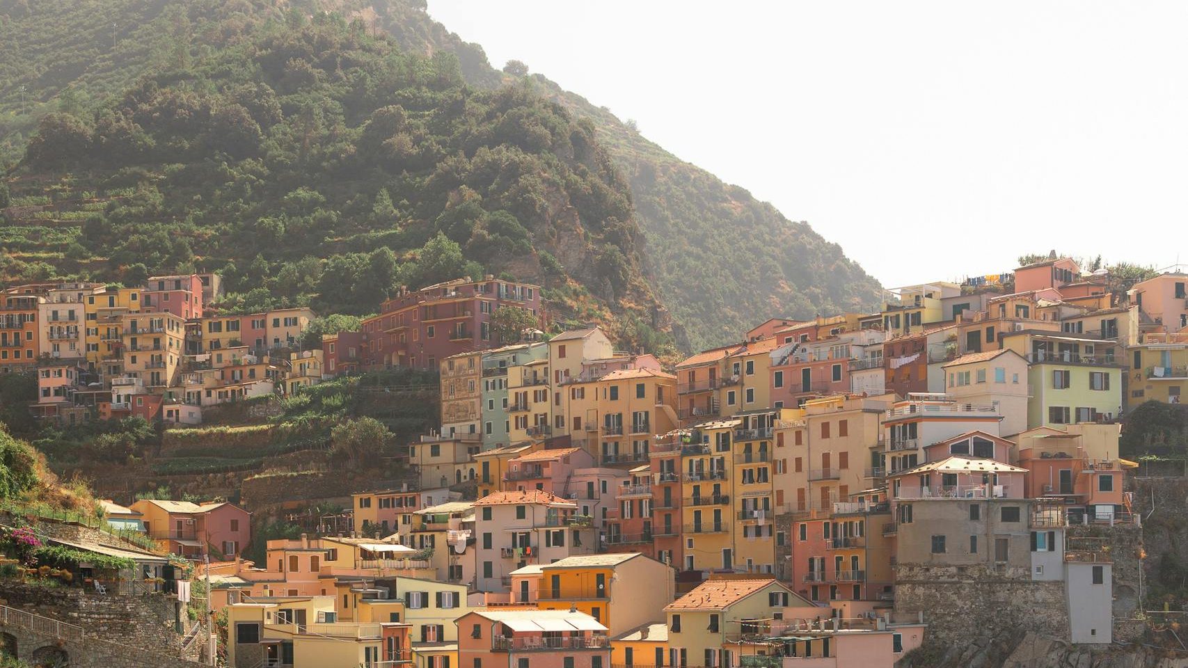 Explore the vibrant clifftop village of Cinque Terre, Italy, showcasing its colorful architecture and stunning coastal views.