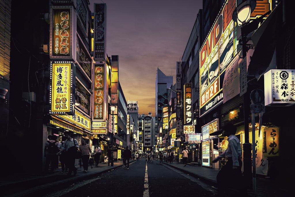 Explore the vibrant nightlife of Shibuya, Tokyo, showcasing neon-lit streets bustling with activity after sunset.