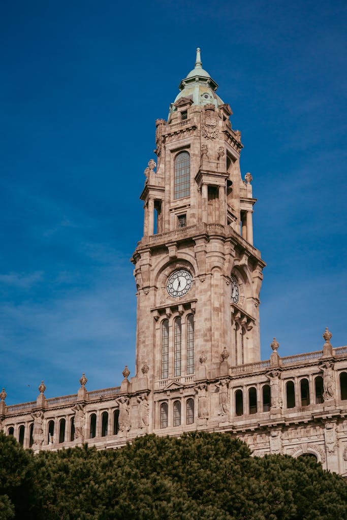 Historic Torre dos Clérigos against clear blue skies in Porto, Portugal.