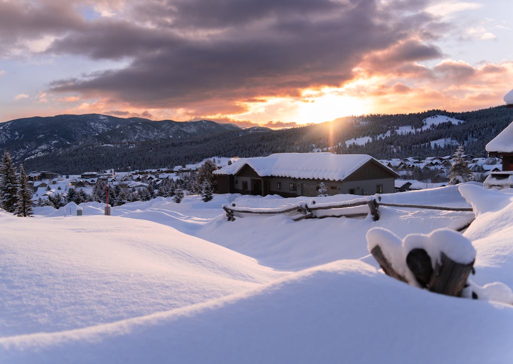 Crisp winter sunset over snow-covered Big Sky, Montana, showcasing serene mountain beauty.